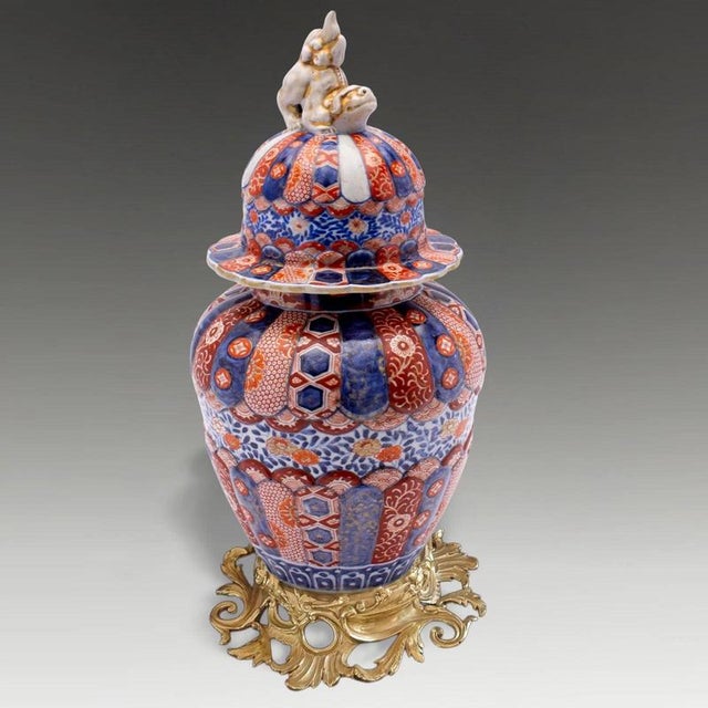 A highly decorative Japanese Arita Imari porcelain temple vase dating to the early Meiji period, distinguished by its...