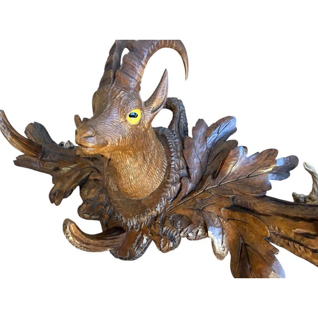 A beautiful 1900s Black Forest goat coat rack — 3 hooks, the goat has glass eyes. Measures 16.5"L. A whimsical folk-art...