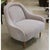 This compact accent chair features a rounded back and gently curved arms that create a soft, sculptural silhouette. The...