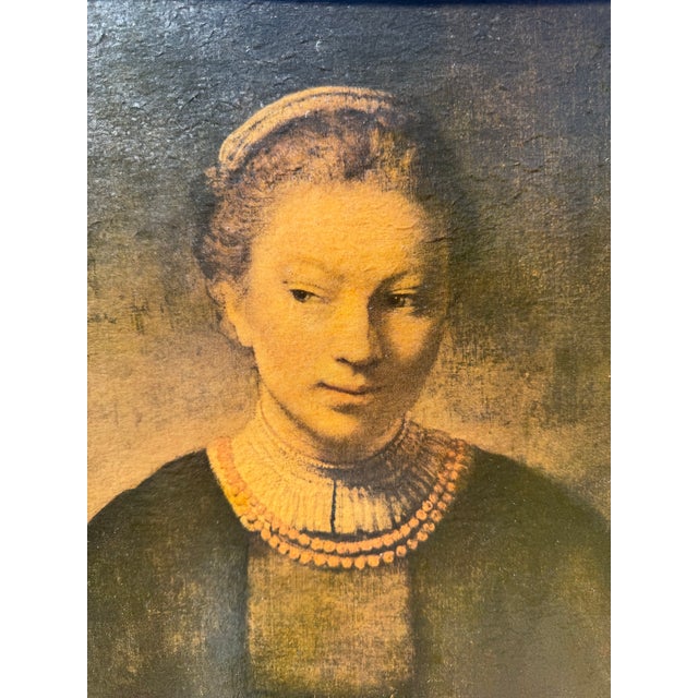This is a vintage reproduction likely dating from the 1960. of Rembrandt’s 1645 work, "Young Woman at an Open Half-Door,"...