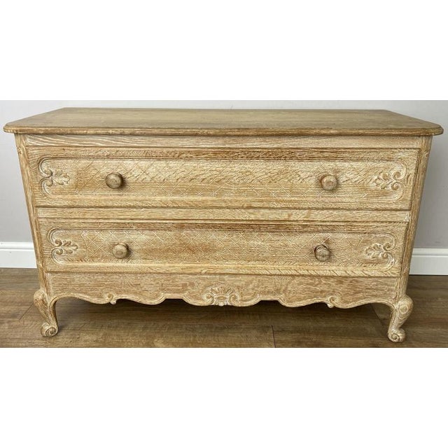 A charming Vintage French Louis chest of drawers in oak, featuring two generously sized drawers, decorative carved fronts,...