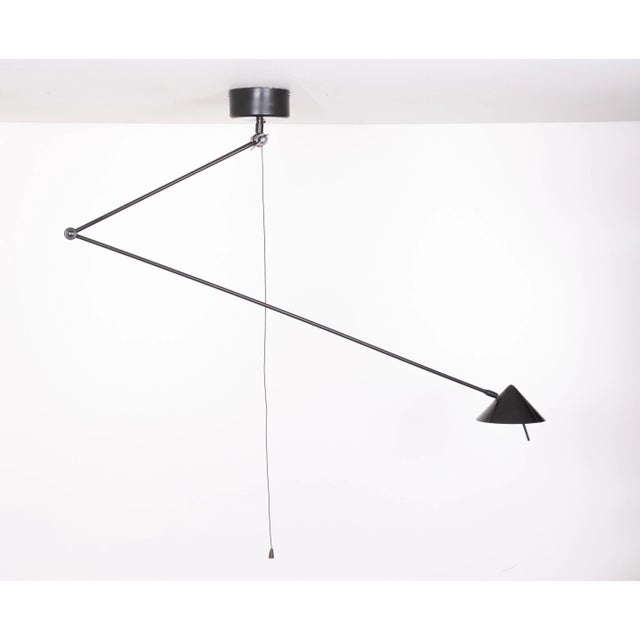 Love this ceiling lamp, so stylish. In black metal. from 1980s. Adjustable in any direction . Halogen, comes with a pull...