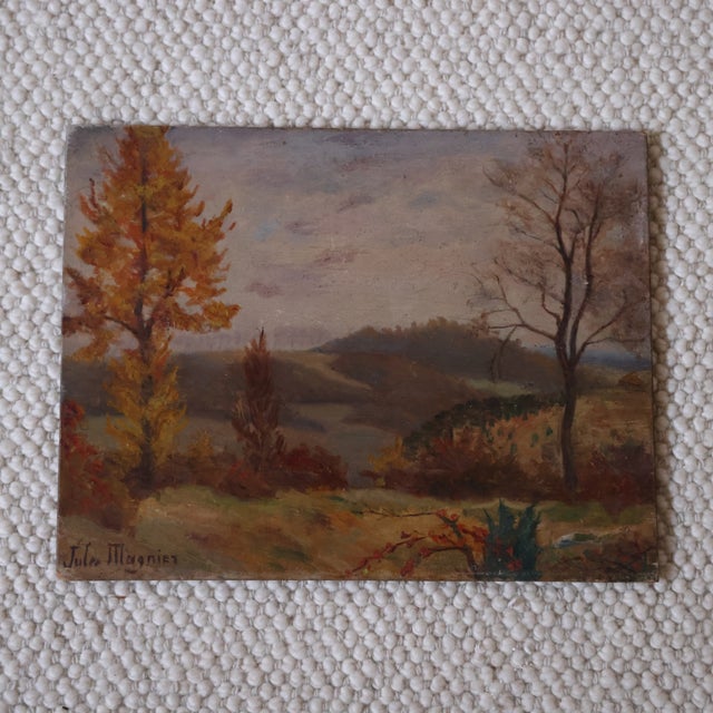 This 20th century French autumn valley painting by Jules Magnier captures a serene countryside view with rich seasonal...