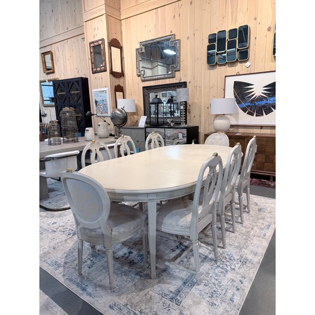 This Gustavian style dining set by K.A. Roos, Helsingborg embodies refined European restraint with its softly painted...