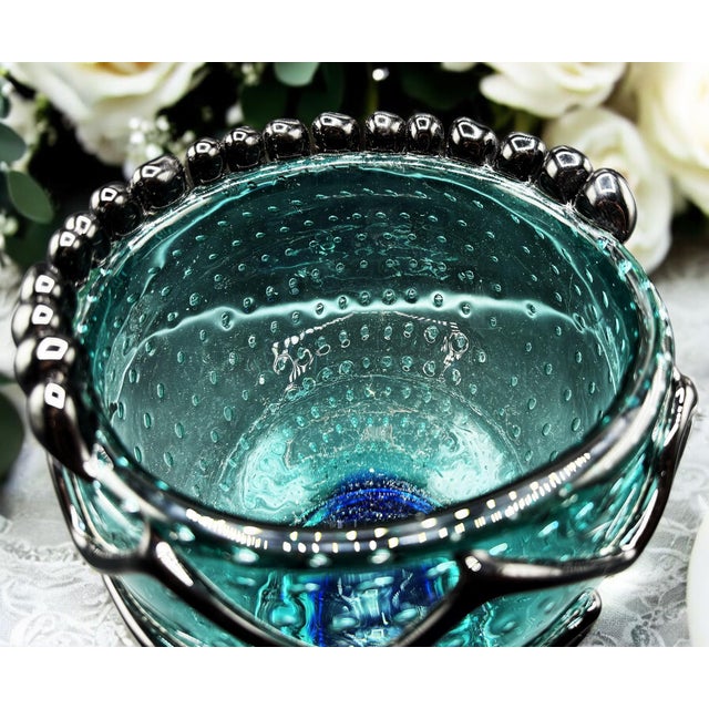 Murano glass vase with a contemporary and creative design, made of blown glass, colored and shaped entirely by hand. This...