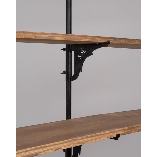 A tall 19th-century French pine display cabinet. The piece features a vertical form with multiple storage areas and a...
