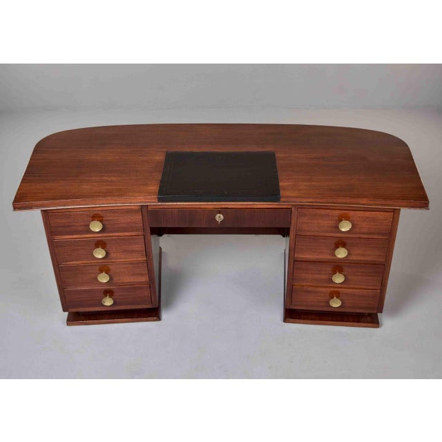 This large French Art Deco executive desk is constructed in mahogany throughout, with a broad top surface featuring...