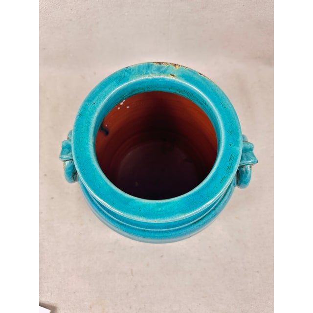 Turquoise crackle glazed ceramic crock with double ring handles. This is a pre-owned item so please see all pictures and...