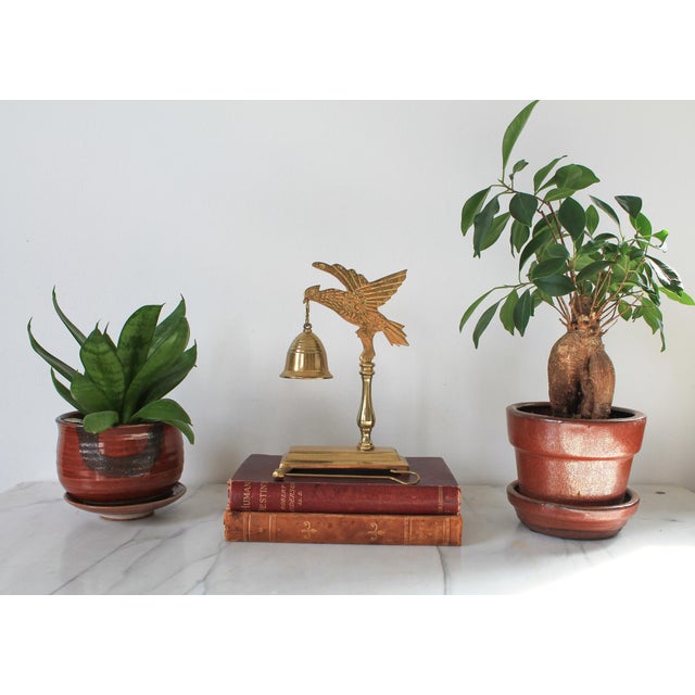 Vintage solid brass bird and bell tabletop chime with intricate detailing. Marked "Crowing Touch" collectible. Hong Kong....