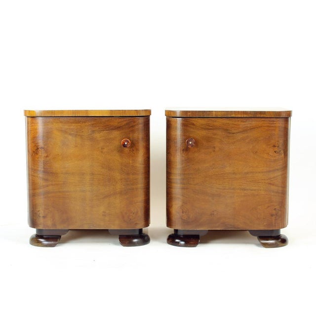 A refined pair of Art Deco bedside tables, produced in Czechoslovakia in the 1930s, showcasing the elegant craftsmanship...