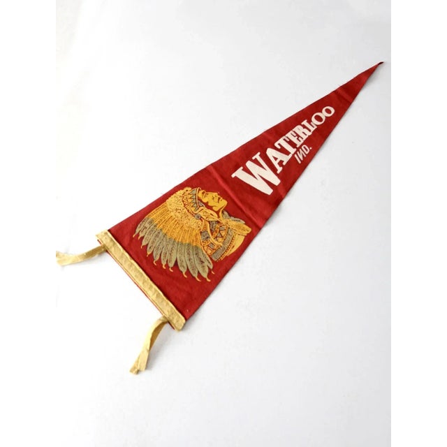 This vintage Waterloo, Indiana sports pennant showcases bold Waterloo lettering and a detailed Indian chief design in...