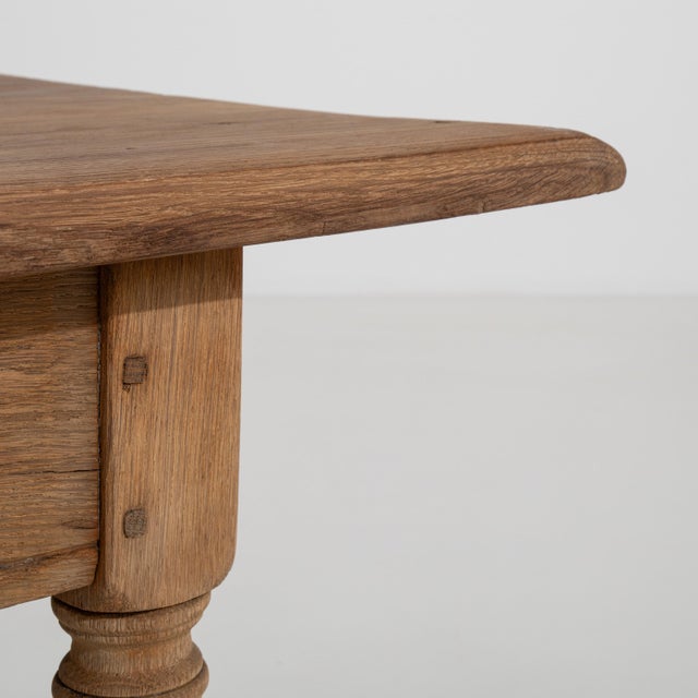 A French provincial coffee table from circa 1970, crafted in wood and featuring a rectangular top with a single drawer....