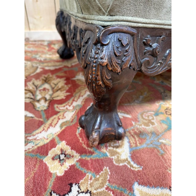 Pair of large wingback armchairs in the English George III style, 19th century. Carefully carved dark wood frames:...