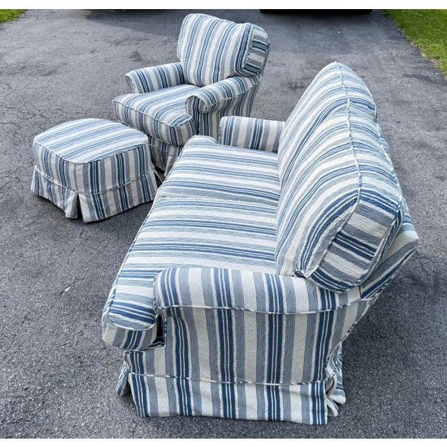 An overstuffed and super comfy slipcover loveseat, rocking and swiveling chair and ottoman from Lillian August Couture,...