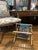 In the style of Mastercraft or Arthur Umanoff, this tubular, folding brass magazine rack will fit right into your mid...