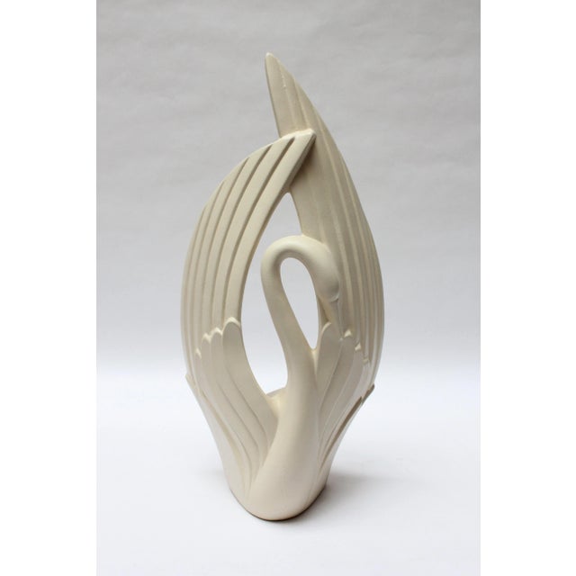 Large, elegant ceramic swan sculpture by Haeger (ca. 1980s, USA). Features a smooth, matte off-white glaze and applied...