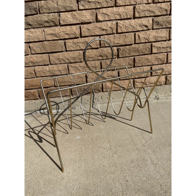 Vintage mid century modern chrome wire magazine rack. Nice sleek style, perfect for any retro or mid century space. All...