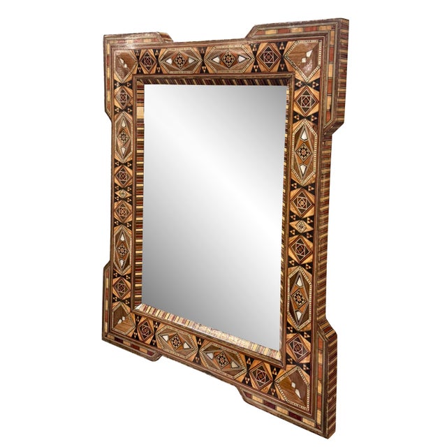This striking vintage mirror highlights the rich artistry of Middle Eastern marquetry, featuring a bold geometric pattern...