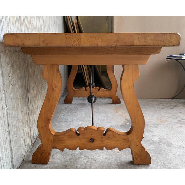 A monumental 20th century Spanish trestle table, having a rectangular framed solid walnut inset board top, resting on hand...