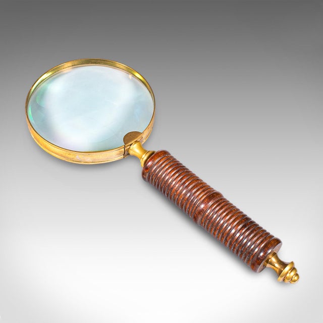 This is an antique ladies sampler magnifier. An English, walnut and brass magnifying glass, dating to the Edwardian...