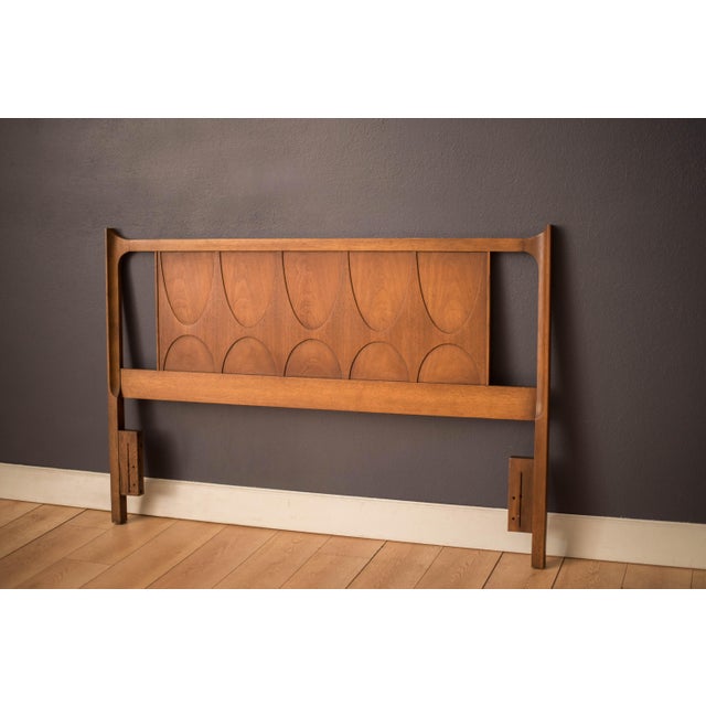Vintage queen Brasilia headboard manufactured by Broyhill Furniture, circa 1960s. This piece is sculpted with the line's...