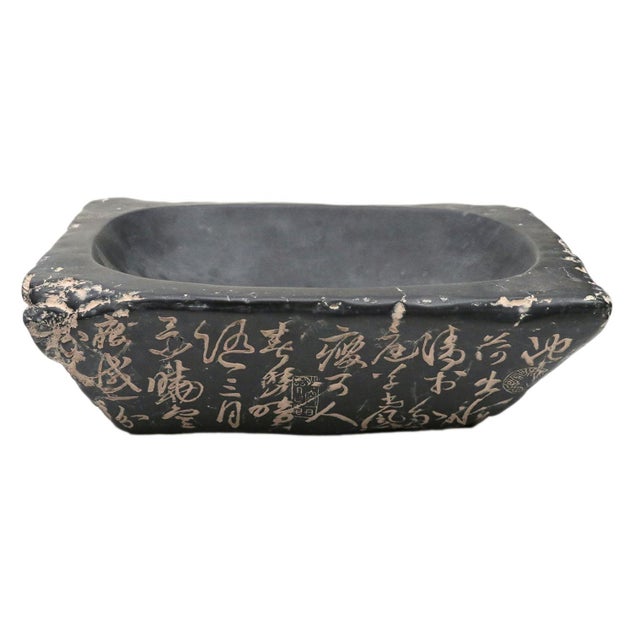 A ceramic rectangular bowl with Chinese cultural markings. Note, the weight is 30 lbs.