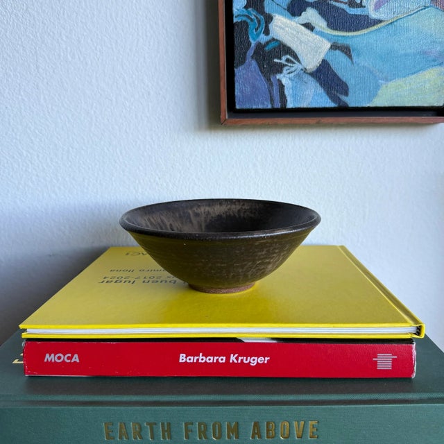 Here is a simple, yet elegant hand-thrown ceramic stoneware bowl with a gorgeous dark mottled glaze. This piece could be...