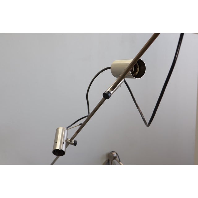 A pair of model 1144 wall lamps designed by Tito Agnoli and produced by O-Luce. Their striking design dates back to the...
