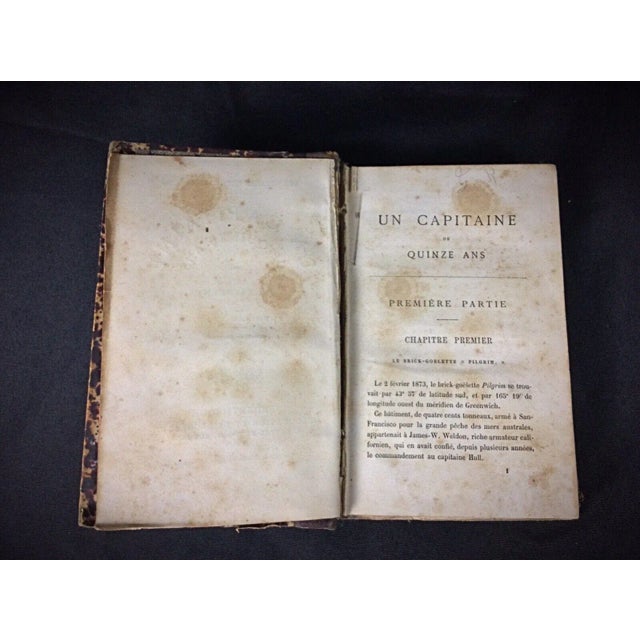 A classic Jules Verne book titled "Un Capitaine de Quinze Ans" (A Captain at Fifteen), first part, 7th edition published...