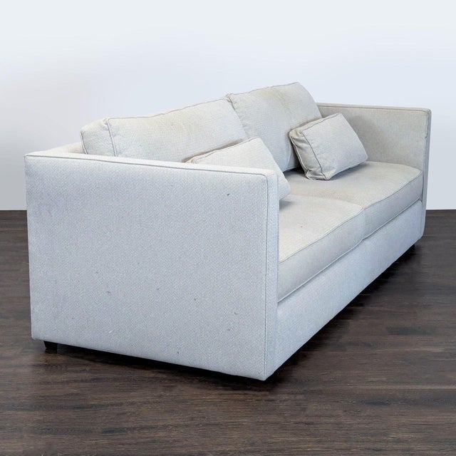 This Room & Board 3-seat sofa features a clean, modern design with straight arms and light gray fabric. It includes two...