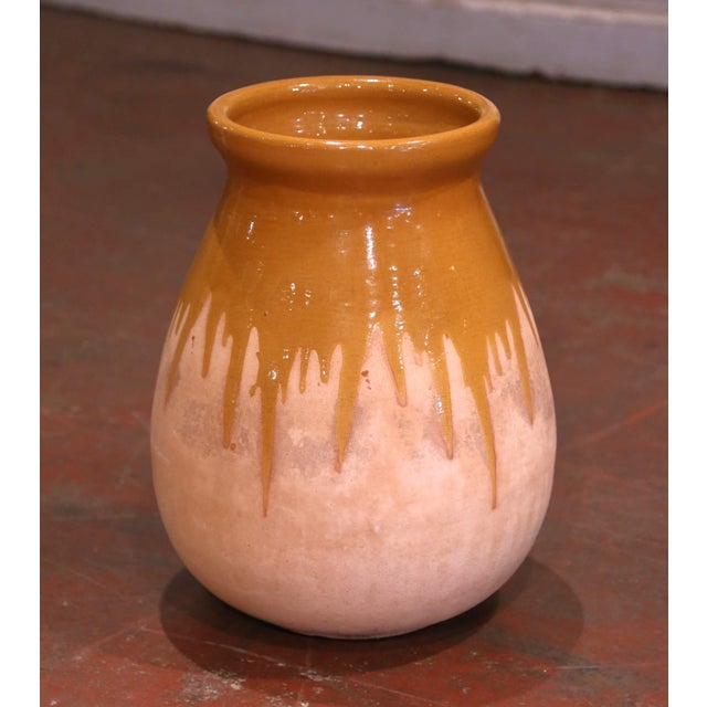 This antique earthenware olive oil jar was created in Southern France, circa 1970. Made of blond clay, the terracotta vase...