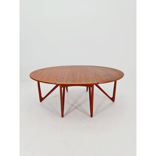 Iconic Danish Mid-Century Modern Drop leaf Teak Dining Table by Niels Koefoed 1960s A Masterpiece of 1960s Engineering &...