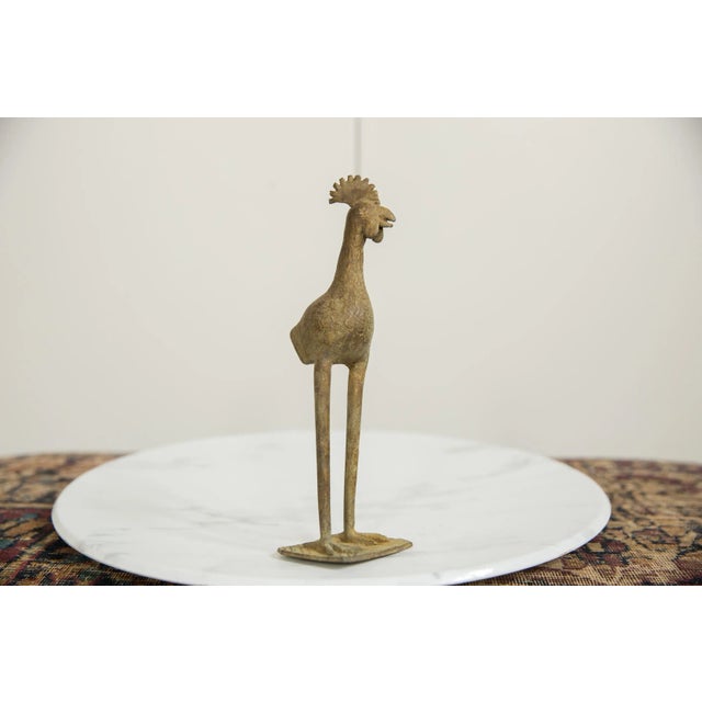 :: Vintage handmade African bronze long legged bird. Circa mid 20th century and possibly older, each figure in this...