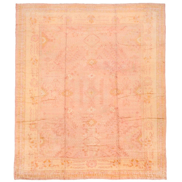An early 20th-century Antique Turkish Oushak rug in soft pink and golds Details rug no. 10697 size 14' 11" x 17' 2" (455 x...