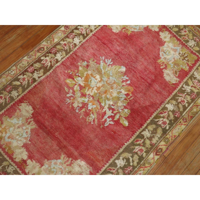 Gorgeous soft colored antique Turkish ghiordes rug with a floral open medallion design and floral border. 3'3'' x 5'