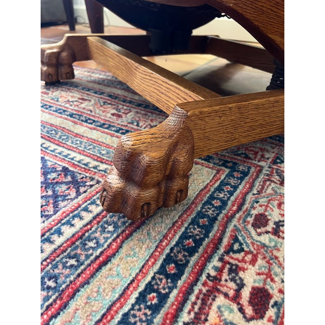 Lovely oak Morris rocking chair in excellent condition. Adjustable back tilt with original iron hardware, lion's feet on...
