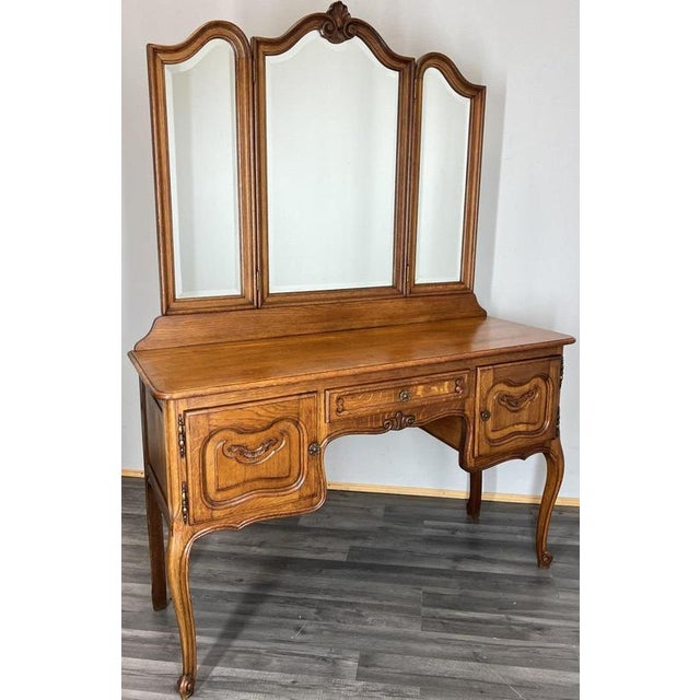 This elegant Vintage French Louis dressing table is beautifully crafted in oak, featuring flowing carved lines, ornate...