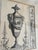 Framed print of "Sepia Pergolesi Urn II" by artist Michelangelo Pergolesi. The piece comes in a light gold frame.