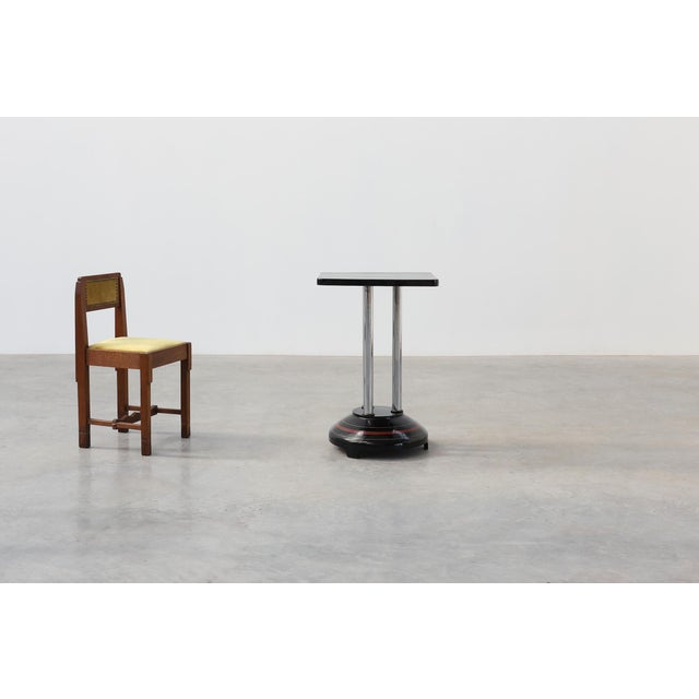 A striking French Art Deco pedestal table dating from the 1920s, showcasing the bold geometric forms and luxurious...
