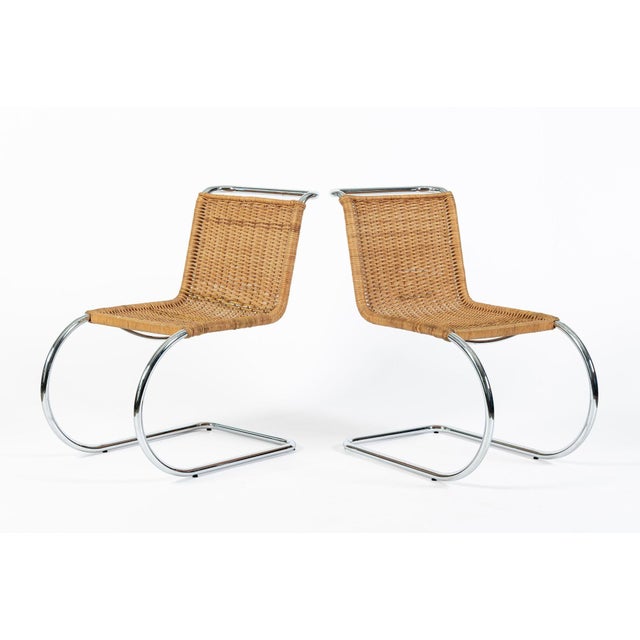 This pair of vintage Mies van der Rohe MR10 cantilevered cane side dining chairs made by Stendig are circa 1970. The MR...