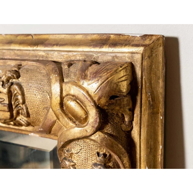 Hand-carved giltwood frame mirror Heraldic shield motif and beveled glass Italy Circa 1875