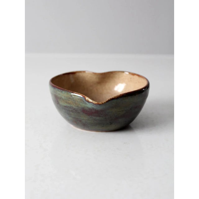 This vintage studio pottery bowl has been signed by the artist and features a handmade ceramic design with a charming...