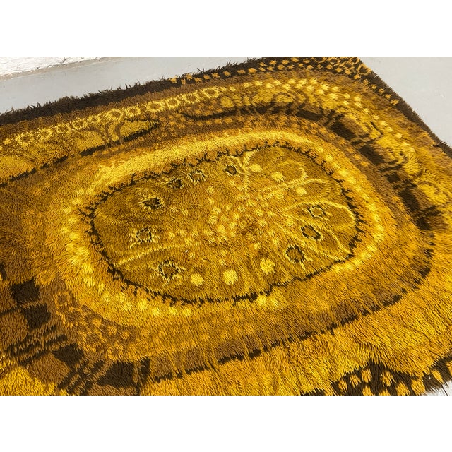 Vintage Mid Century Modern Rya rug, c. 1970’s featuring a rich palette of golden mustard, caramel, and deep brown tones...