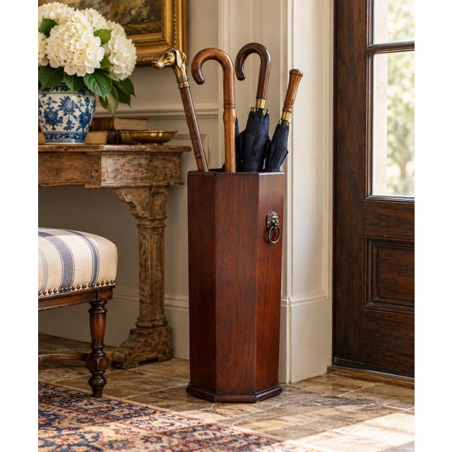 A handsome vintage wooden umbrella stand distinguished by its architectural octagonal form, warm reddish-brown finish, and...