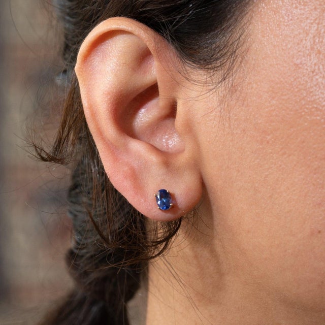 A matched pair of AAA-grade tanzanites glows in a rich violet-blue in these solid 14K gold oval solitaire stud earrings,...