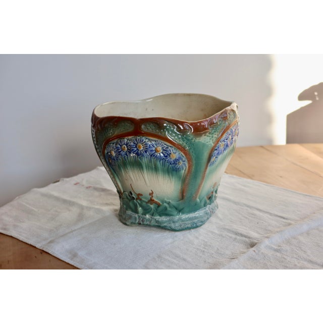 Large earthenware cachepot with a raised floral design, in an Art Nouveau style with organic lines and shades of seafoam...
