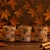 Warm up your home with the soft glow of this Autumn Leaf Glass Votive Holder Set. Featuring a beautiful marbled amber...