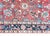 A hand knotted early 20th century Persian Heriz rug with a large-scale floral and leaf patterned field surrounded by a...