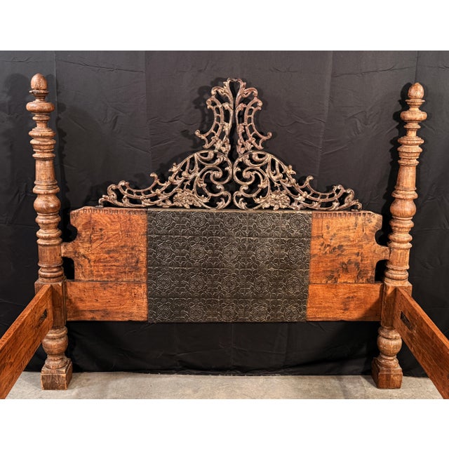 This substantial four poster bed combines heavily turned hardwood posts with decorative heavy forged iron panel overlays...