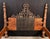 This substantial four poster bed combines heavily turned hardwood posts with decorative heavy forged iron panel overlays...